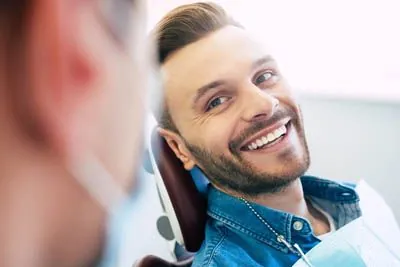 man smiling during his cosmetic dentistry appointment at Smiles Dental Center